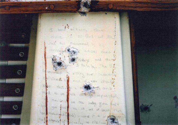 Bullet holes and blood surround a note thought to be written by Dzhokhar Tsarnaev in the boat where he was apprehended in Watertown, Mass. The government released transcripts and stills of the note on March 10, 2015.