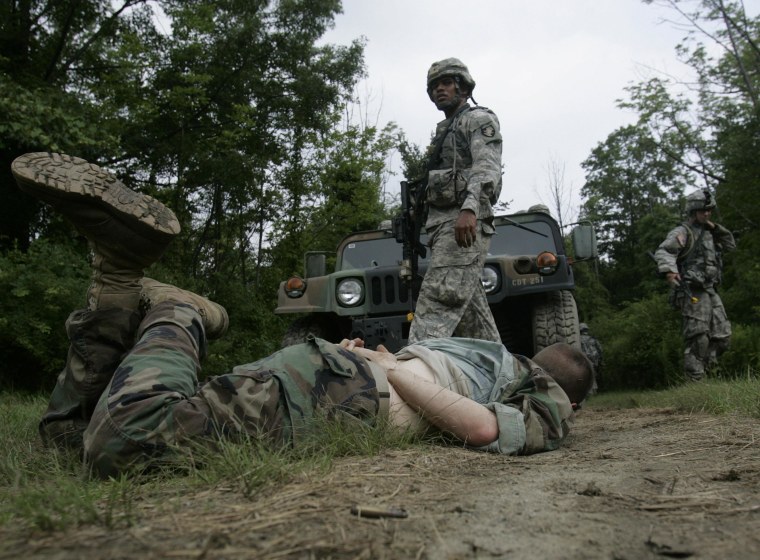 Image: Cadet Gibson Sale of Pago Pago, American Samoa, walks past a simulated insurgent casualty during a military exercise at the United States Military Academy