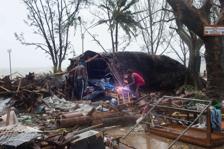 Image: Residents search through storm damage caused by Cyclone Pam.