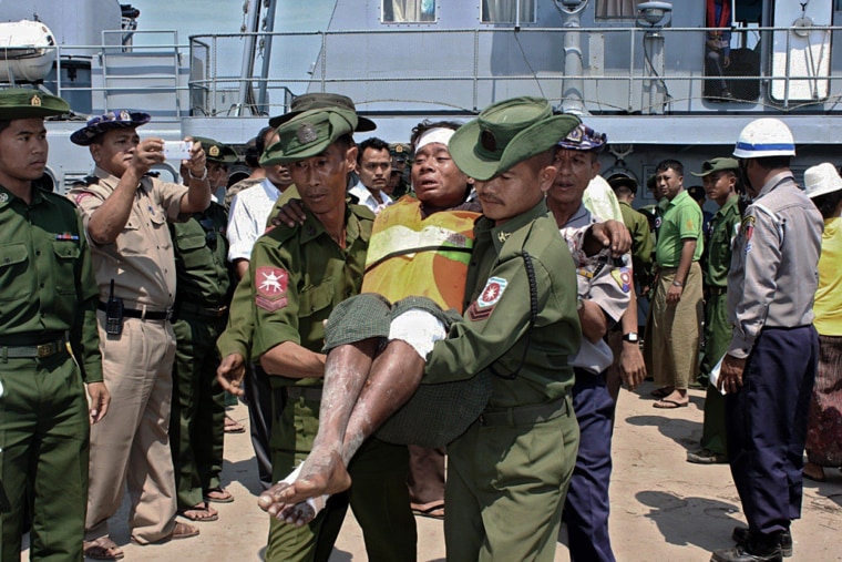 Image: A survivor from an overloaded ferry that sank is carried