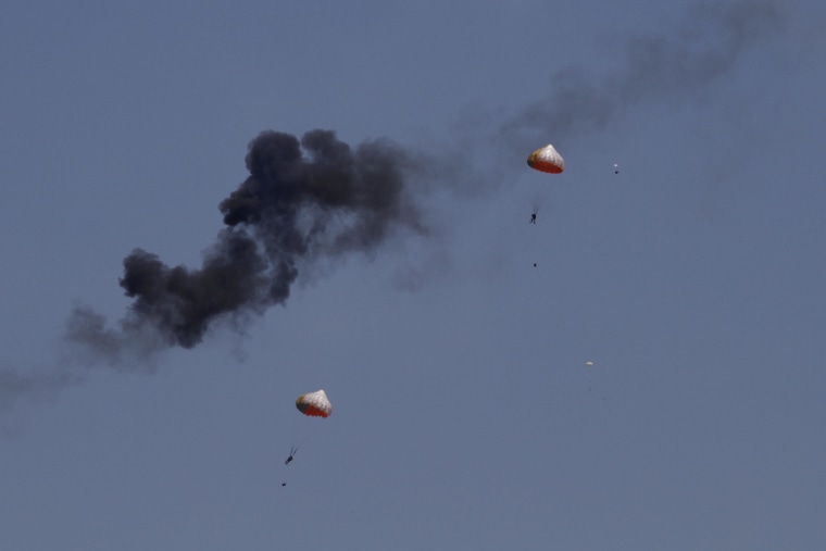 Pilots from Indonesia’s Jupiter aerobatics team are ejected after a mid-air collision during a practice session at the Langkawi International Maritime and Aerospace (LIMA) exhibition in Langkawi, Malaysia, on Sunday, March 15, 2015.