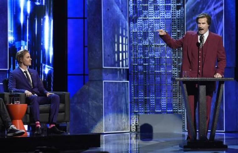 Will Ferrell, right, appears in character as Ron Burgundy from "The Anchorman" films, as Justin Bieber looks on at the Comedy Central Roast of Justin Bieber.