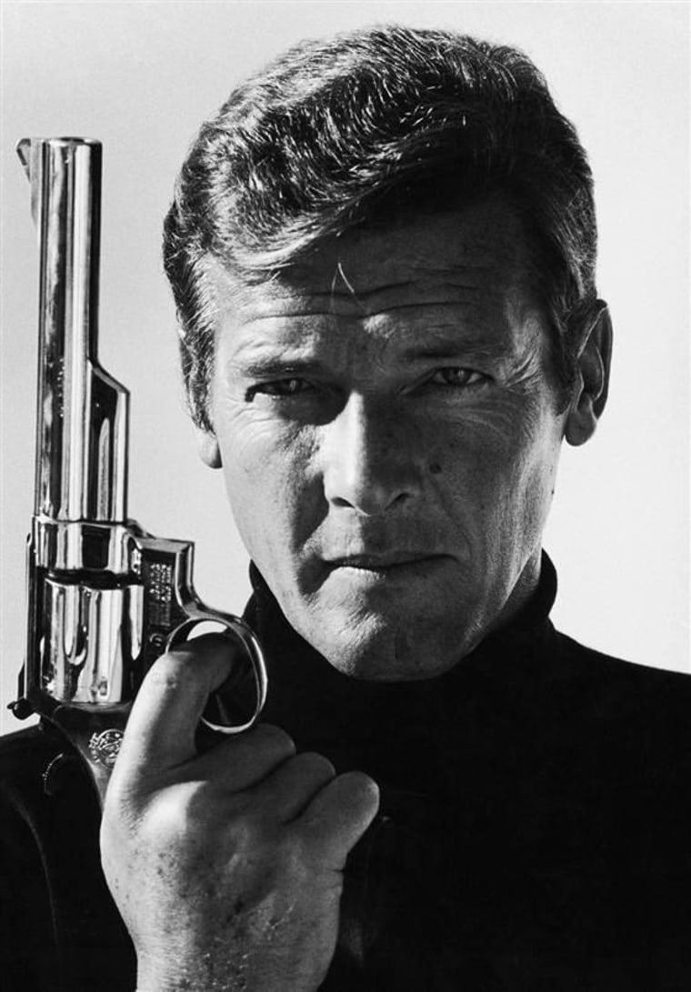 British actor Roger Moore as James Bond, posing with a gun in the early 1980s.