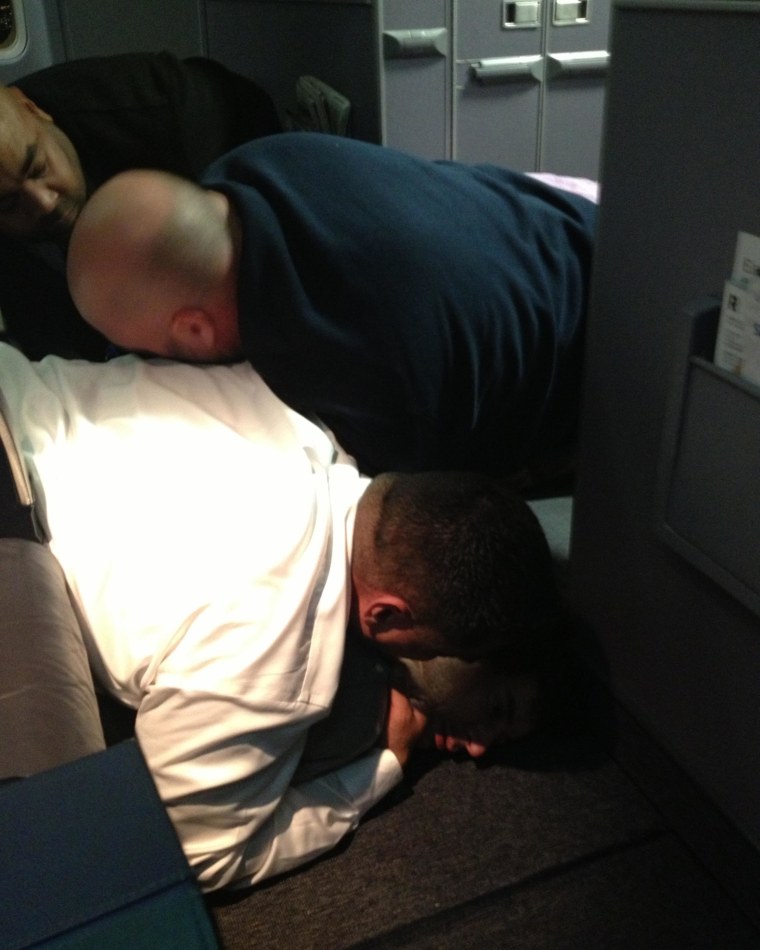 Image: A passenger is restrained  on United Flight 1074 (Dulles -&gt; Denver) returned to Dulles Internation Airport After a passenger failed to comply with crew instructions.