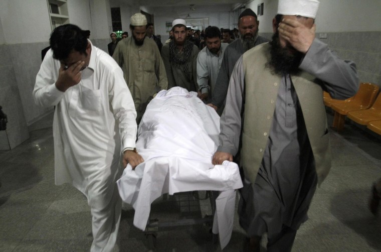 Image: Relatives move the body of Samiullah Afridi at a hospital in Peshawar