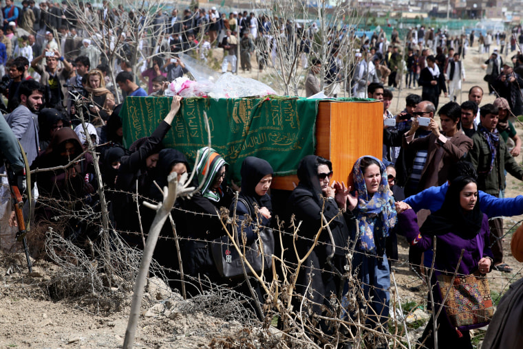 Image: Afghan women carry the coffin of a woman who was beaten to death by a mob.