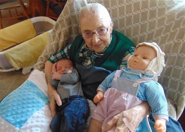 Laura Kayizzi's grandson is held by his great-great grandmother, who was born in 1915.