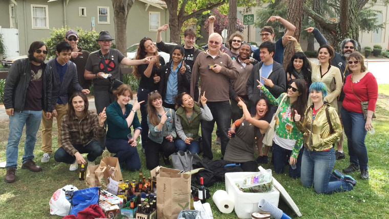 After Nigel Guest, center, accidentally sent a mass email to thousands of people, triggering a frenzy of funny and angry responses, many of the less distressed recipients gathered for a celebratory picnic, where they gifted Guest with a can of Spam.