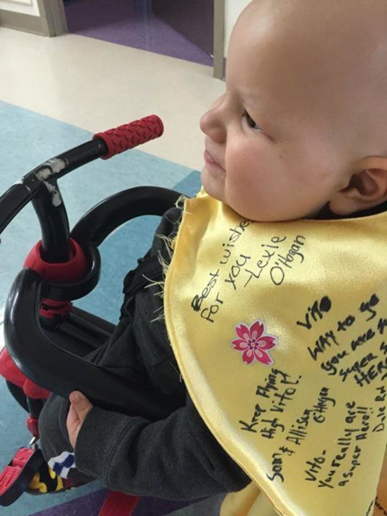 Vito Skaro, now cancer-free, wears a cape signed by hospital staffers and other supporters.