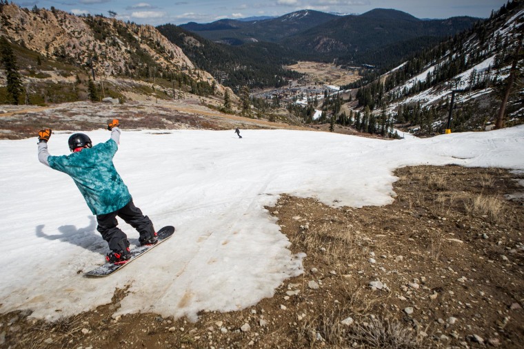 Image: Snowboarder navigates through patches of dirt