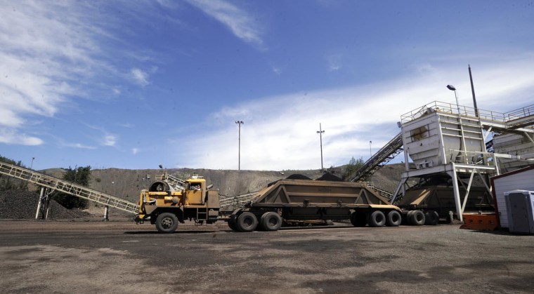 A three trailer truck takes on a load of phosphate ore at a hopper near Monsanto Company's South Rasmussen Mine Operation on Thursday, July 16, 2009 near Soda Springs, Idaho.