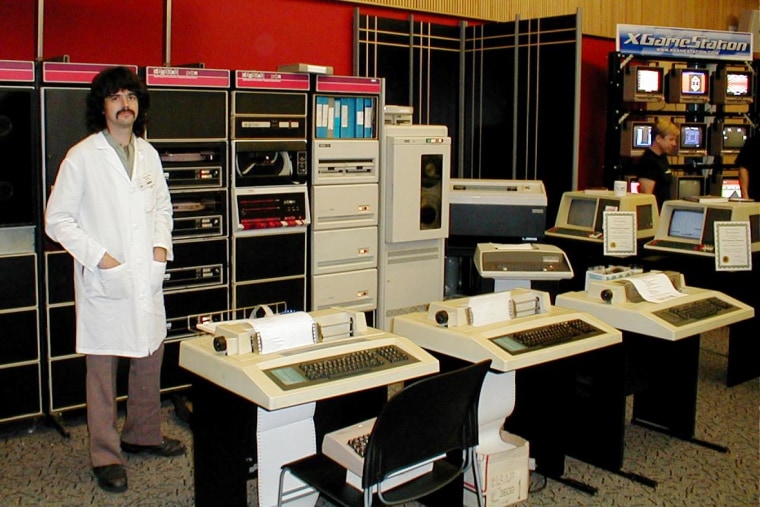 Pavl Zachary complements his '70s-era PDP 11/40 computer with period-appropriate sideburns and mustache at Vintage Computer Festival East 7.0 in 2011.