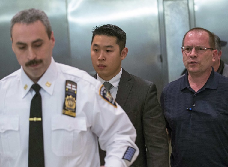 Image: NYPD officer Liang departs the criminal courtroom after an arraignment hearing in the Brooklyn borough of New York City