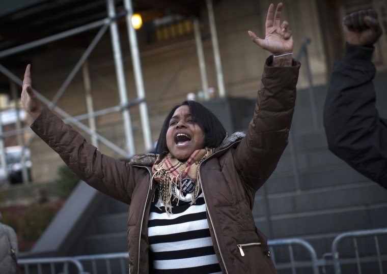 Image: Erica Garner, the daughter of Eric Garner leads a chant at a protest and candlelight vigil outside the 120th police precinct in the Staten Island borough of New York City