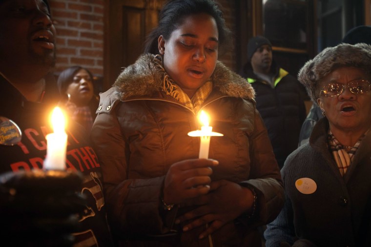 Image: Eric Garner's daughter Erica takes part in candlelight vigil at the site where her father died in July last year after being put in a chokehold, during a Martin Luther King Day service in New York