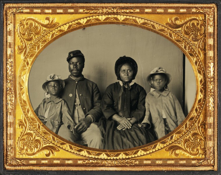 Quarter-Plate Ambrotype taken between 1863 and 1865. Image depicts a Black Union Army private and his wife and twin daughters. This image has recently become something of an icon of the African American experience during the American Civil War.  
