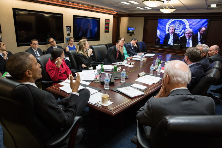 President Barack Obama and Vice President Joe Biden, with the national security team, participate in a secure video teleconference from the Situation Room of the White House with Secretary of State John Kerry, Energy Secretary Ernest Moniz and the U.S. team in Lausanne, Switzerland, negotiating with Iran, March 31, 2015.