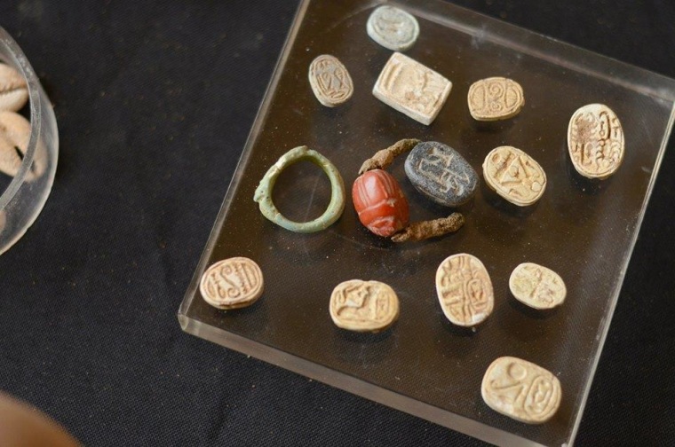 Scarabs and seal rings are laid out on a display stand in Jerusalem. Some of the seals bear the names of Egyptian pharaohs.