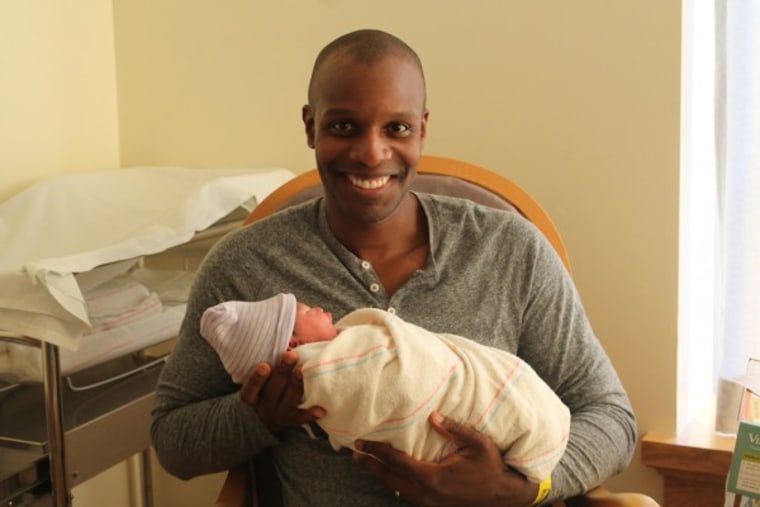 Doyin Richards and his youngest daughter on her birth day.