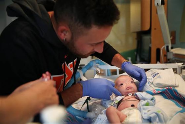 Troy Thompson tends to his son, Eli at the NICU at USA Children’s &amp; Women’s Hospital in Mobile, Ala., on March 19, 2015.