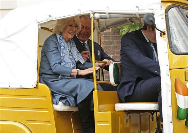 LONDON, ENGLAND - MARCH 26:  Camilla, Duchess of Cornwall and Prince Charles, Prince of Wales ride in a rickshaw at Clarence House on March 26, 2015 i...