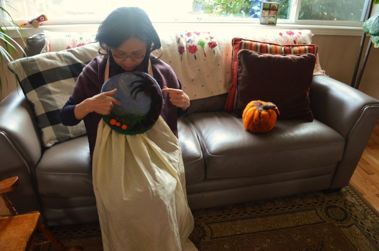 My-Duyen sitting at her home after the interview sharing some of her handmade felted crafts.