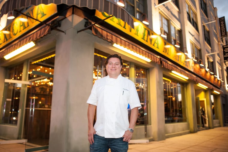 Chef Julian Medina poses in front of one of his restaurants, Tacuba.