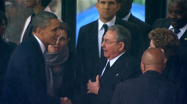 Image: U.S. President Obama shaking hands with Cuban President Castro during Nelson Mandela's national memorial service in Johannesburg