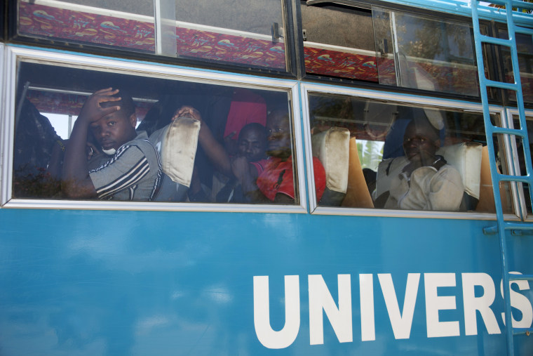Image: Injured university students leave in a bus after treatment at Kenyatta National Hospital