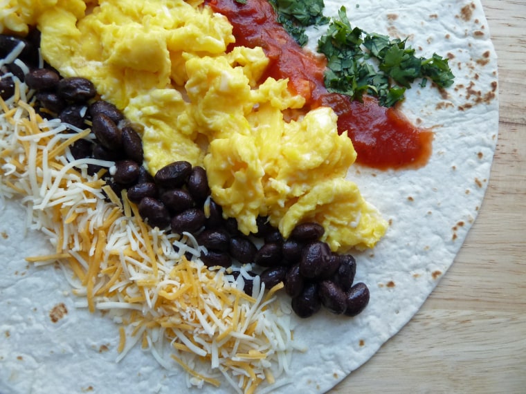 Breakfast burritos with black beans, salsa, cheese and sour cream