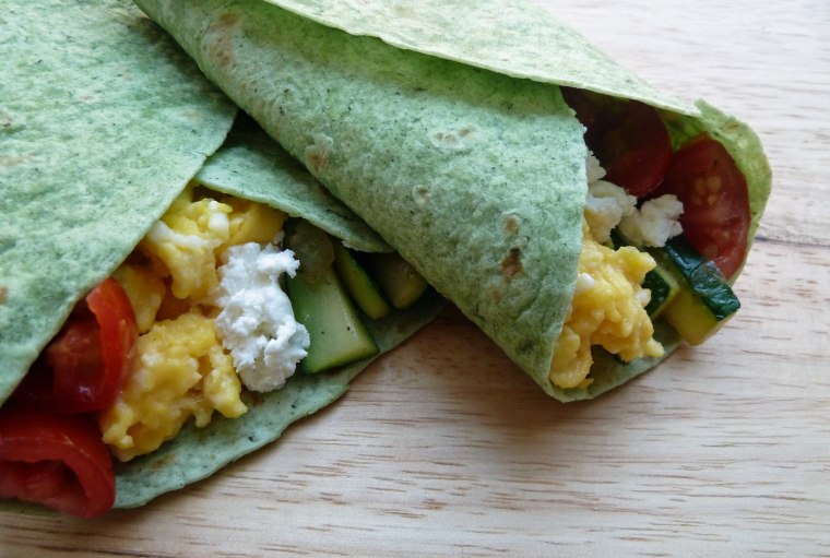 Breakfast burritos with zucchini, tomatoes and goat cheese