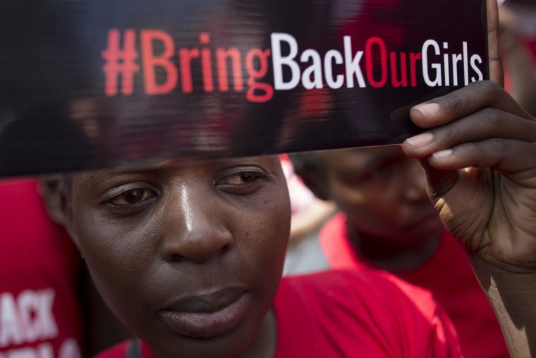 A Kenyan activist looks on as she holds up a placard during a demonstration to protest against kidnapping of Nigerian school girls by Nigeria's Islamist militant group Boko Haram, in Nairobi, Kenya, 15 May 2014