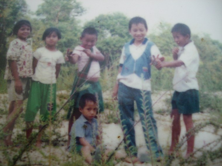 Ta Kwe Say (seated) with his brother and cousins in Burma.