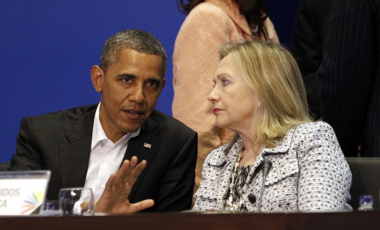 Image: U.S. President Barack Obama and Secretary of State Hillary Clinton talk during the plenary session of the Summit of the Americas in Cartagena