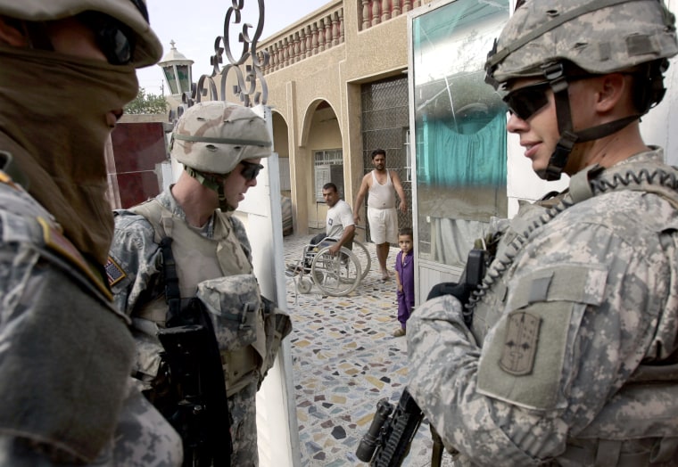 Image: U.S. soldiers and interpreter, left, in Baghdad in Oct. 2006