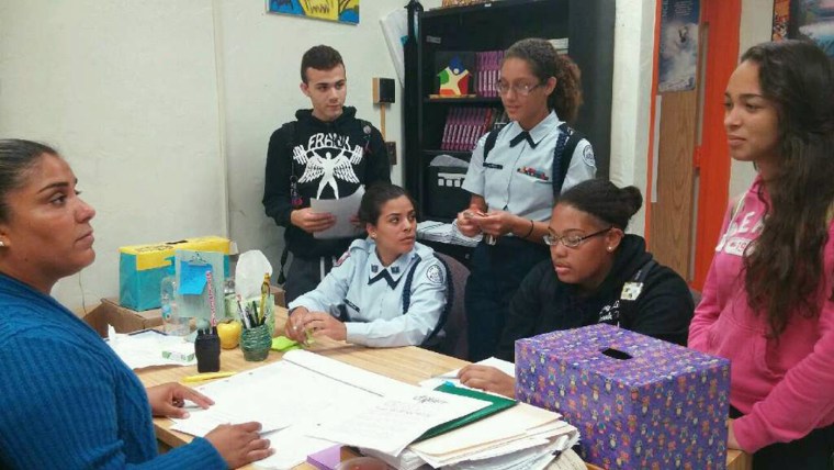 Mariafe Arteaga, a Community in Schools site coordinator in Homestead, Florida, explains to high school students about opportunities to participate in mentoring programs and other projects and coaches them on the importance of being role models in a recent meeting in April 2015.
