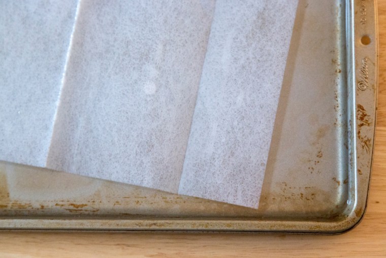 Spring cleaning hacks - use a dryer sheet to clean the stains off a baking sheet