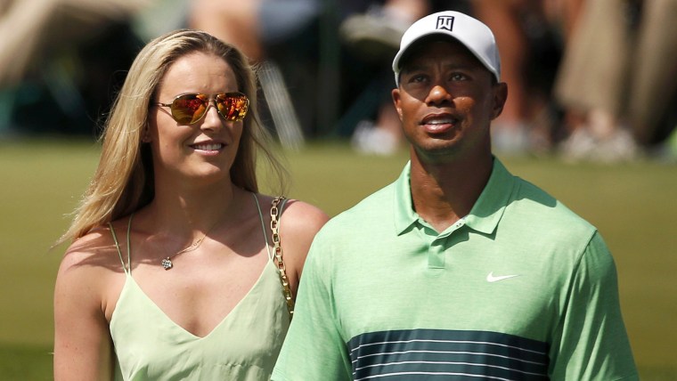 Skier Lindsey Vonn stands next to her boyfriend, U.S. golfer Tiger Woods