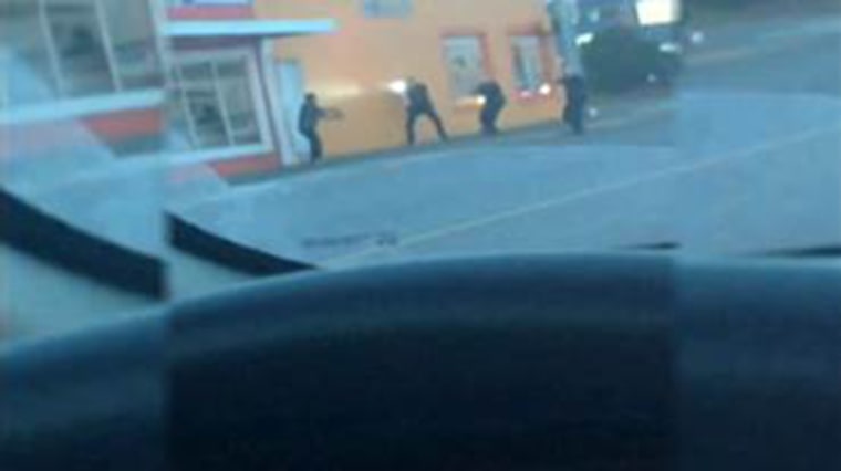 Raw cell phone video shows police officers in Washington State fatally shooting a man who was reportedly throwing rocks at them.