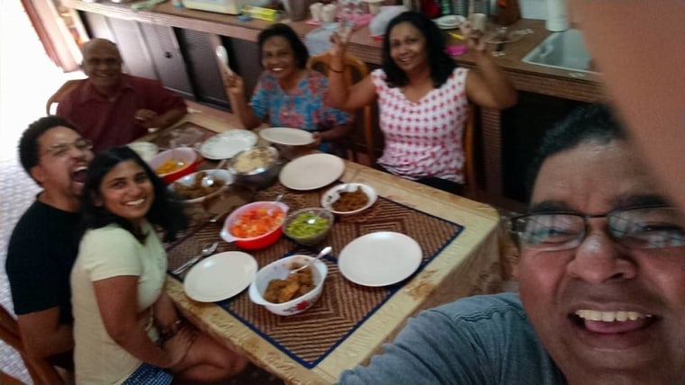 Dashini and her family take a picture together after a meal, during a recent trip back to Malaysia.