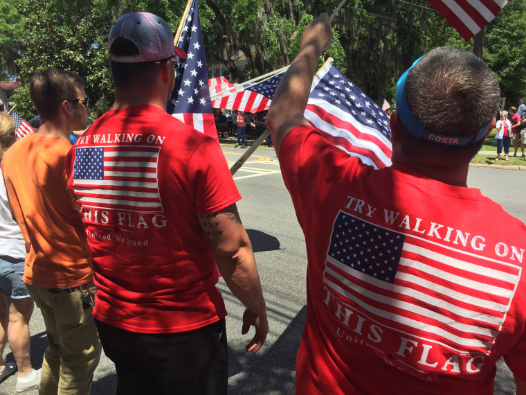 Demonstrators wave American flags at Valdosta State University.