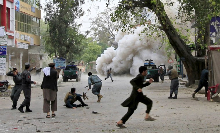 Image: People run for cover after an explosion in Jalalabad