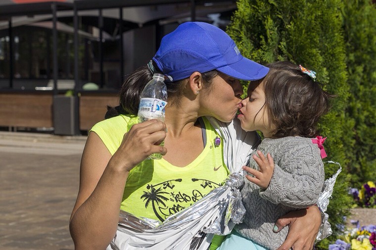 Linda Leon snuggles with her daughter after the Nike Women's Half Marathon in April 2013.
