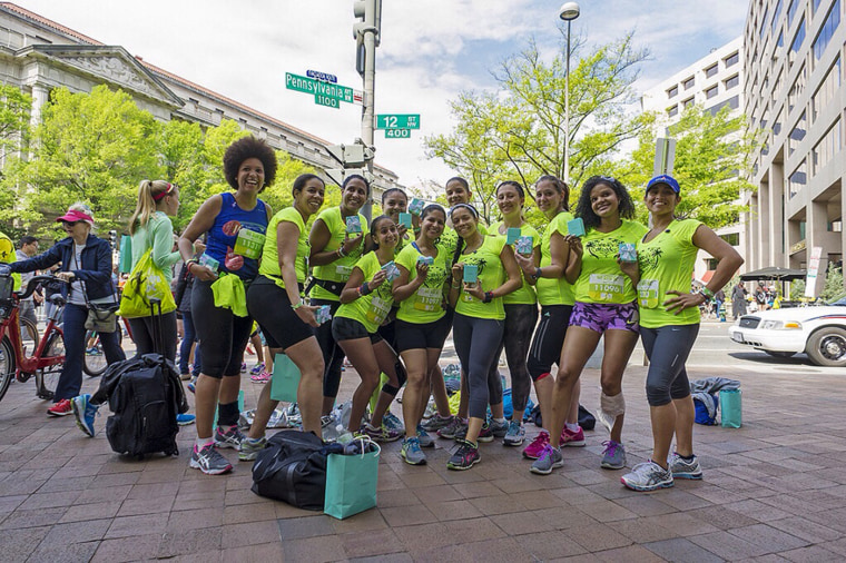 Runners hold up engraved Nike Tiffay necklaces they received for participating in the April 2013 Nike Women’s Half Marathon in Washington, D.C. From  left to right: Jessica Lebron, Diana Muriel, Jasmine Sanchez, Maddeline Tineo-Cuddy,  Cynthia Guerrero, Ana B. Linda Leon,  Michelle Favela, Lina Baez, Karen Filippi.
