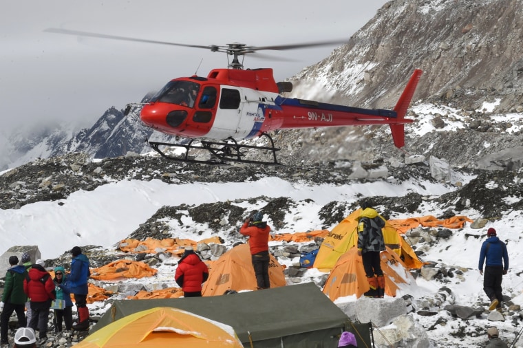 Image: A rescue helicopter comes in for a landing to pick up the injured from Everest Base Camp on April 26, 2015.