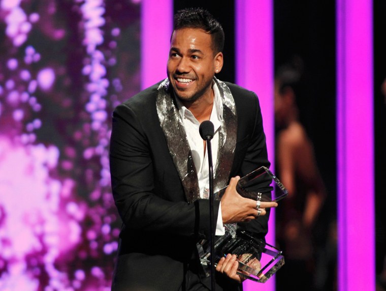 Image: Singer Roberto Santos accepts a pair of awards at the 2015 Latin Billboard Awards in Coral Gables