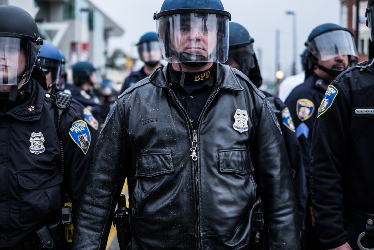 A police officer stands guard during protests in Baltimore on April 26, 2015.