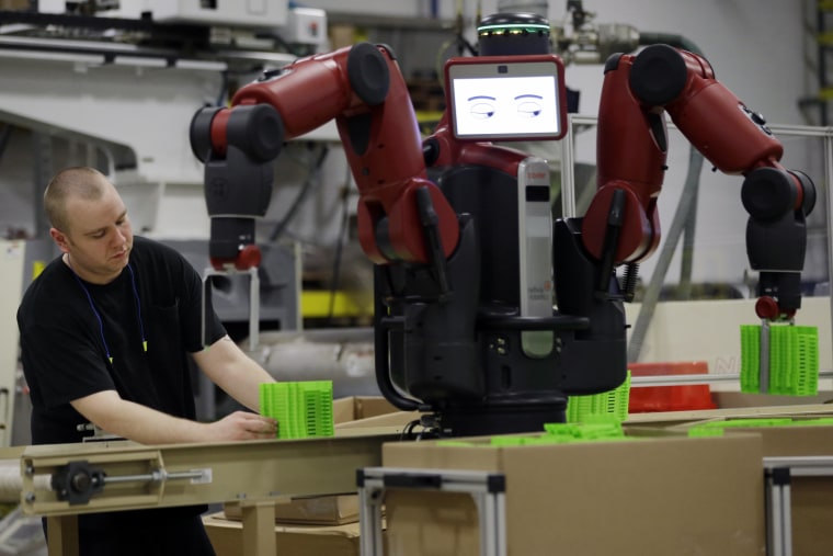 Image: A technician works with Baxter, an adaptive robot in Hatfiled, Pa.