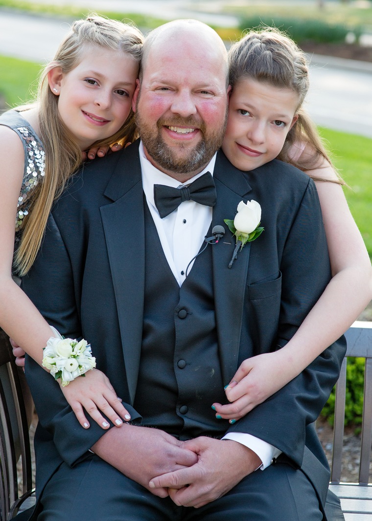 Sisters Maren and Zoe with their father, 42-year-old Charlie Kwentus, who has a brain tumor and recently stopped all treatment.