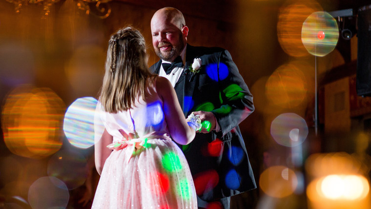 Sisters Maren and Zoe dance with their father, 42-year-old Charlie Kwentus, who has a brain tumor and recently stopped all treatment.